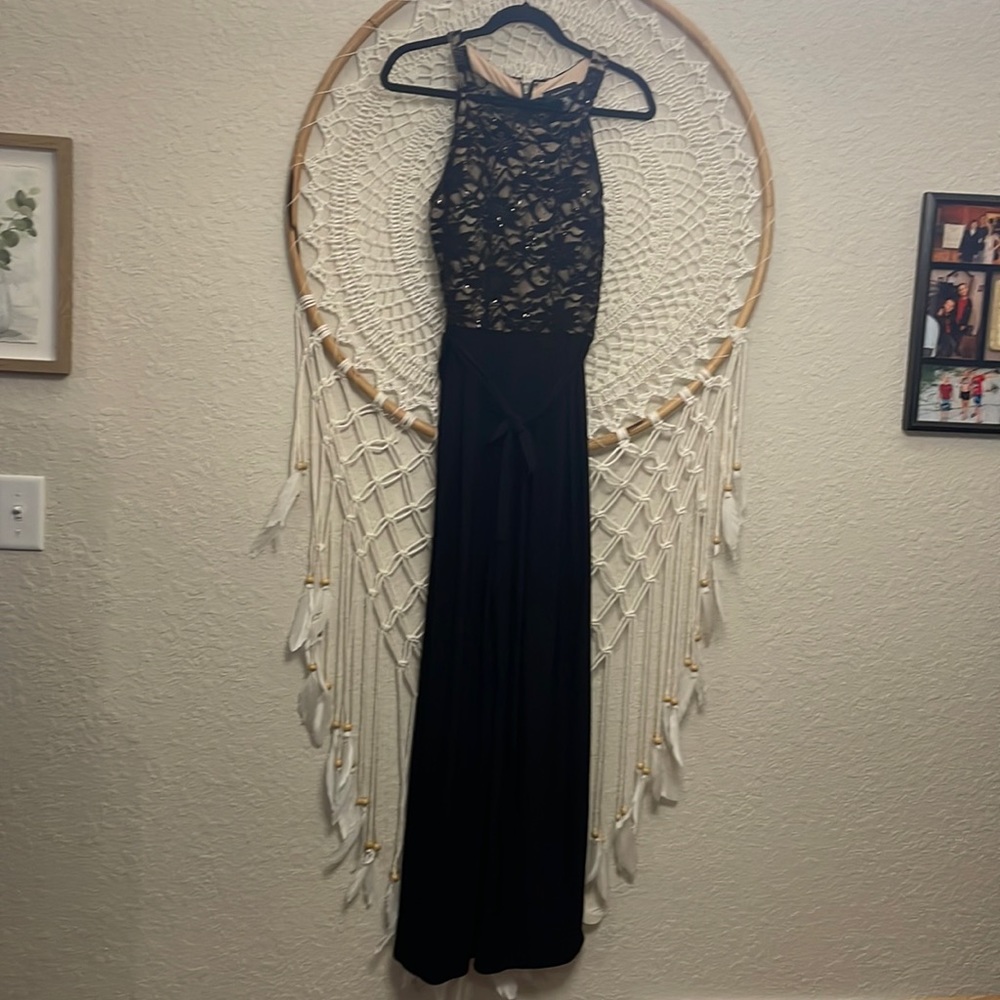 Beautiful Jumpsuit see through in back. Worn once. Very slimming